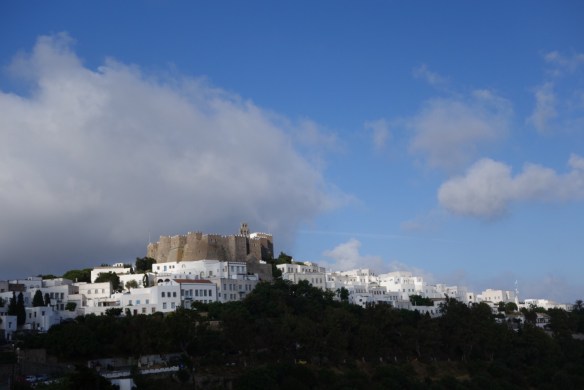 The monastery rises above the village of Chora.